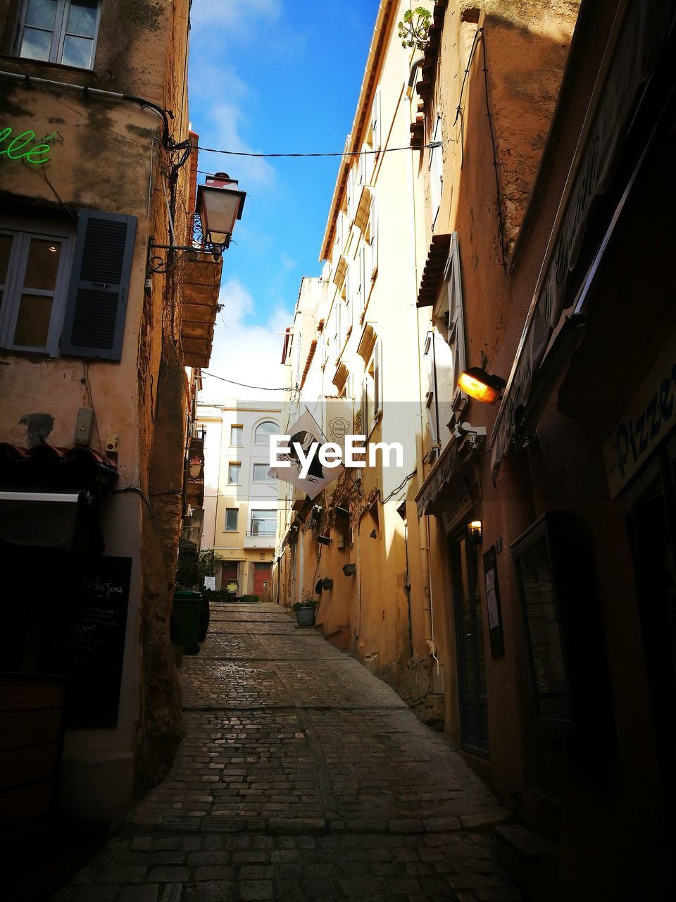 STREET AMIDST CITY AGAINST SKY