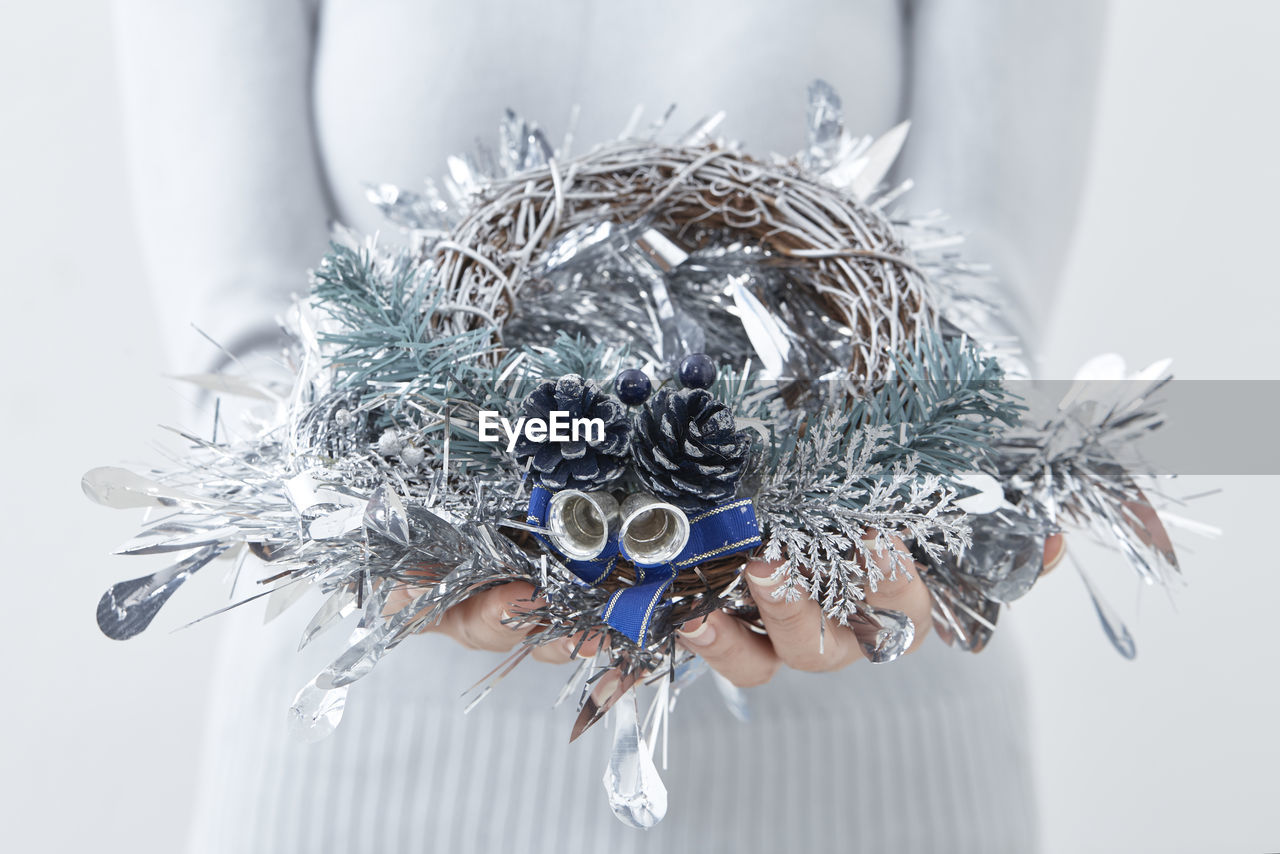 Close-up of woman holding christmas decoration