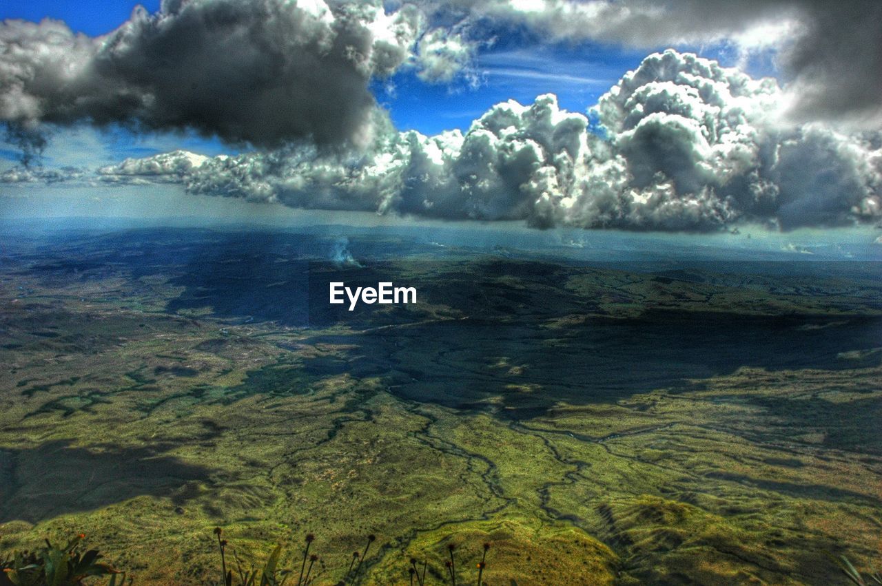 Scenic view of mountains against cloudy sky