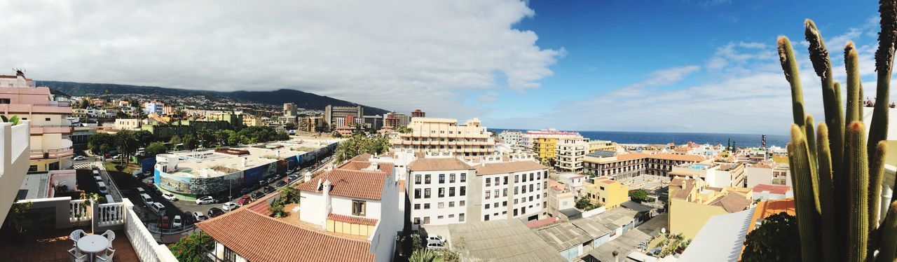 High angle view of townscape by sea against sky