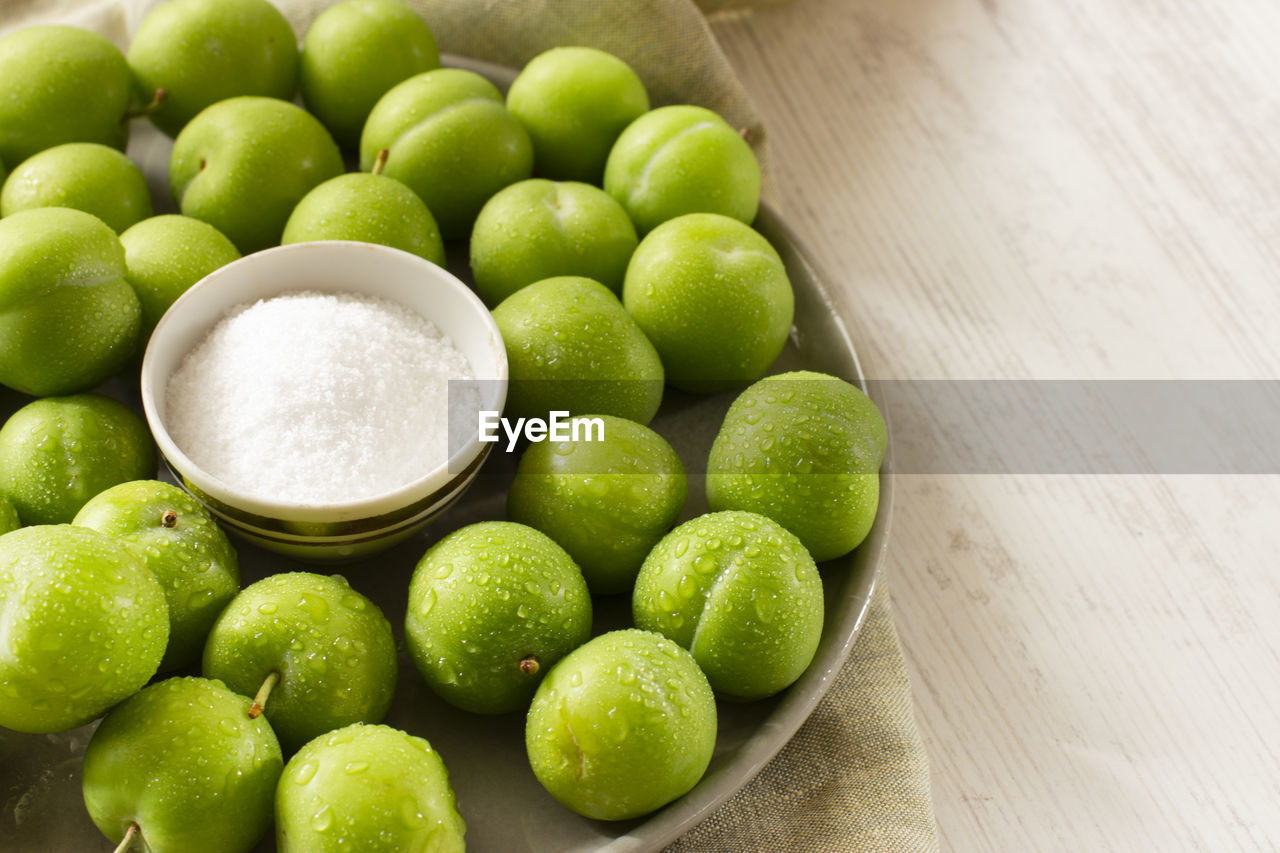 Unripe sour green plums with salt. traditional turkish snack.