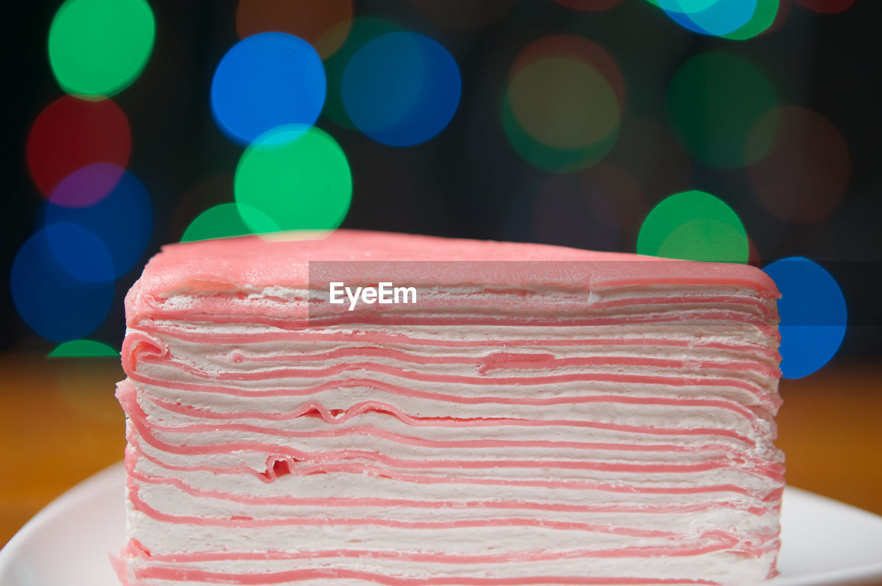 CLOSE-UP OF CAKE ON TABLE AGAINST BLURRED BACKGROUND