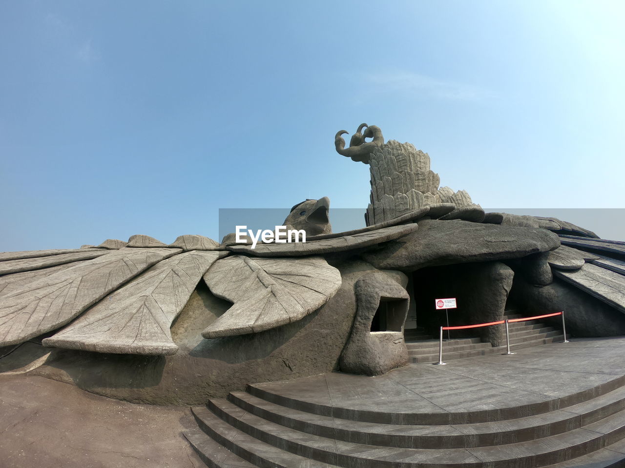 LOW ANGLE VIEW OF STATUE ON ROOF