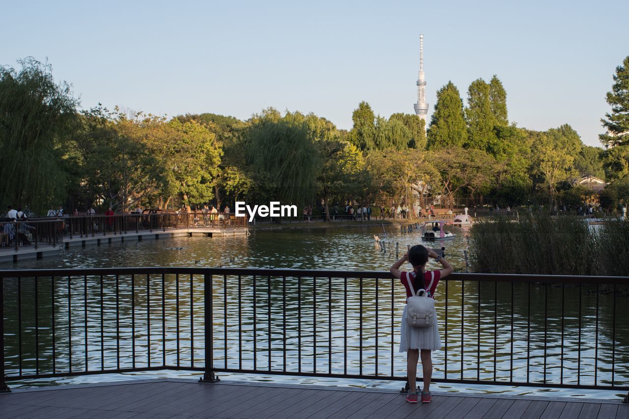 PEOPLE STANDING IN FRONT OF RIVER