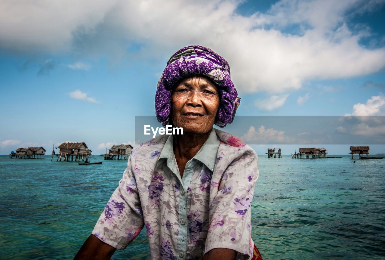 Portrait of senior woman against sea