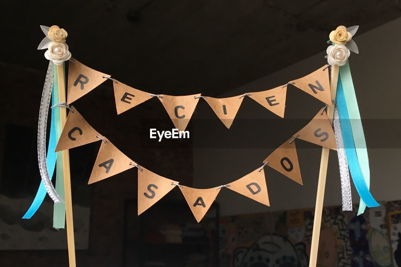 LOW ANGLE VIEW OF INFORMATION SIGN HANGING ON CLOTHESLINE