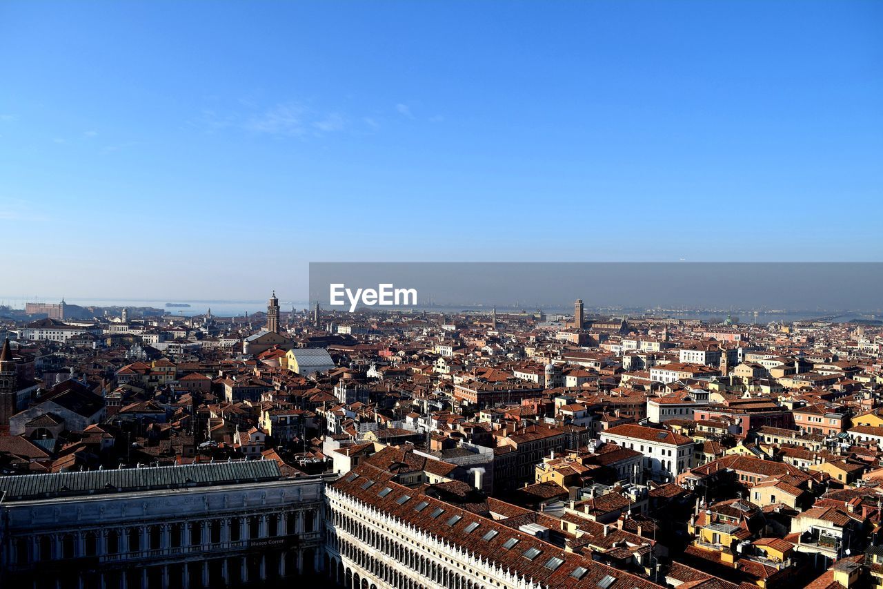 High angle view of townscape against blue sky