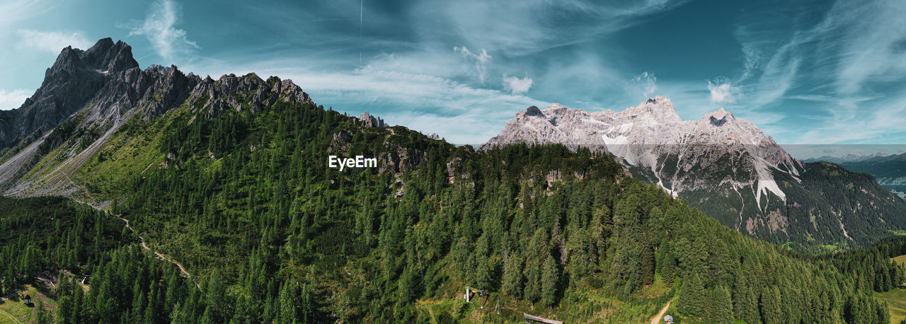 Panoramic view of trees and mountains against sky