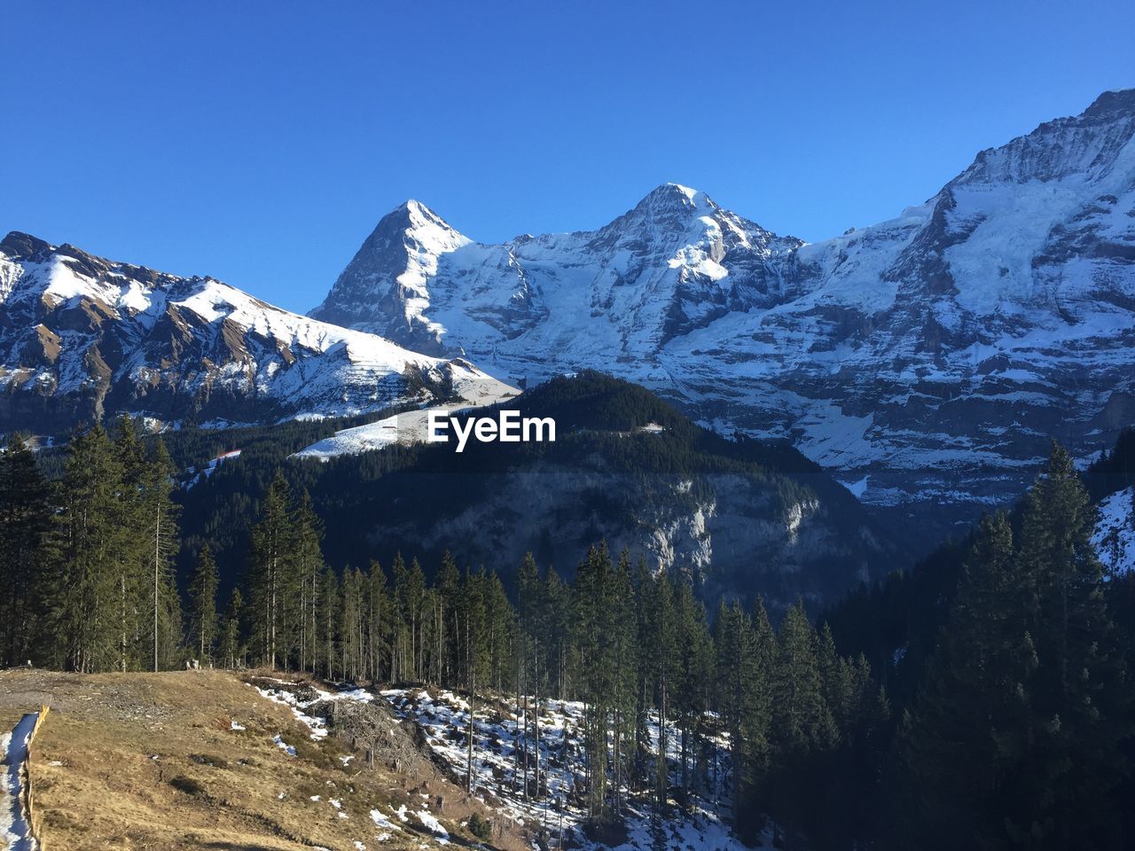 Scenic view of snowcapped mountains against clear sky