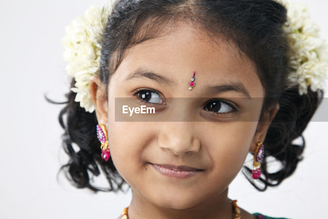 Smiling girl looking away over white background