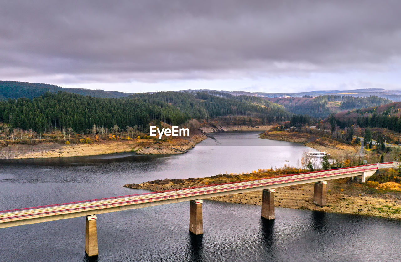 Aerial view over a bridge over a dam in a german mountain range