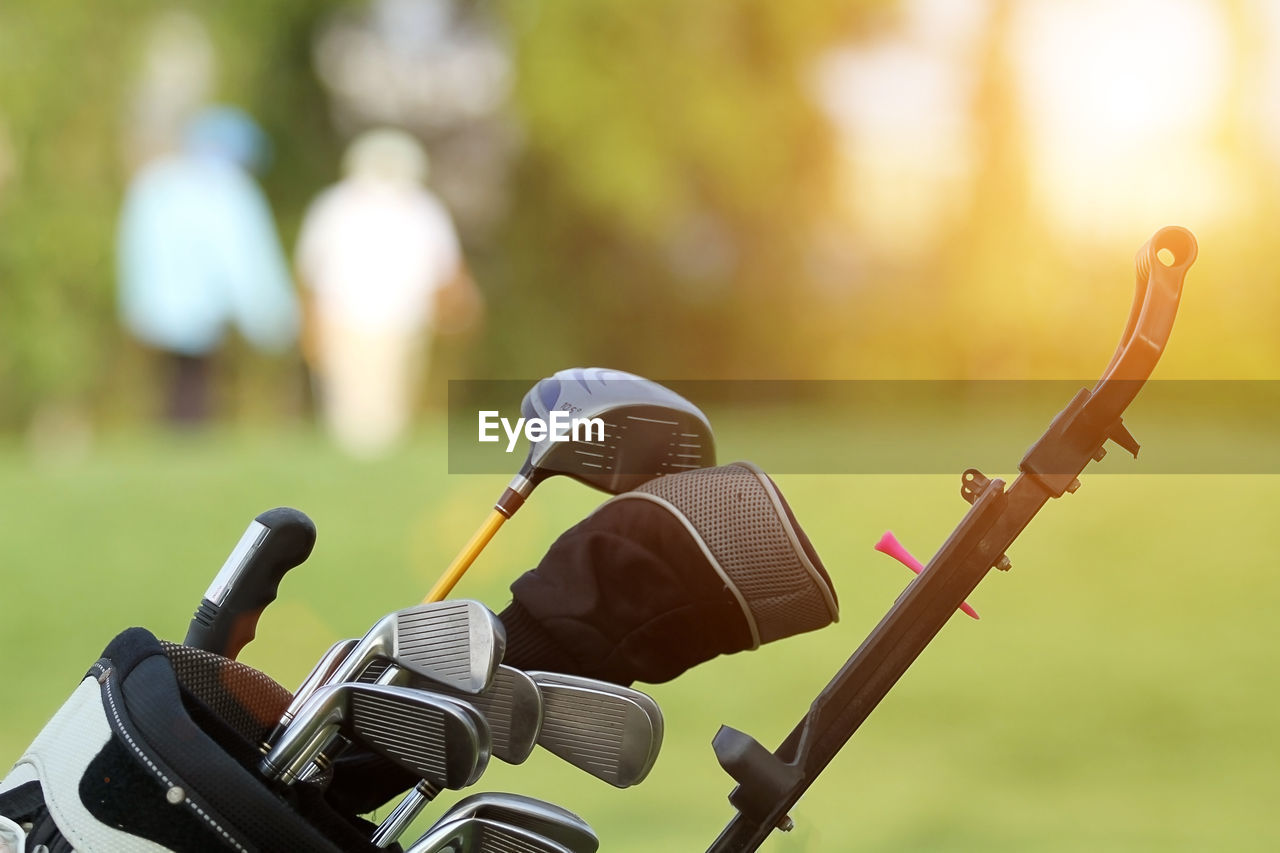 Close-up of golf club on grassy field