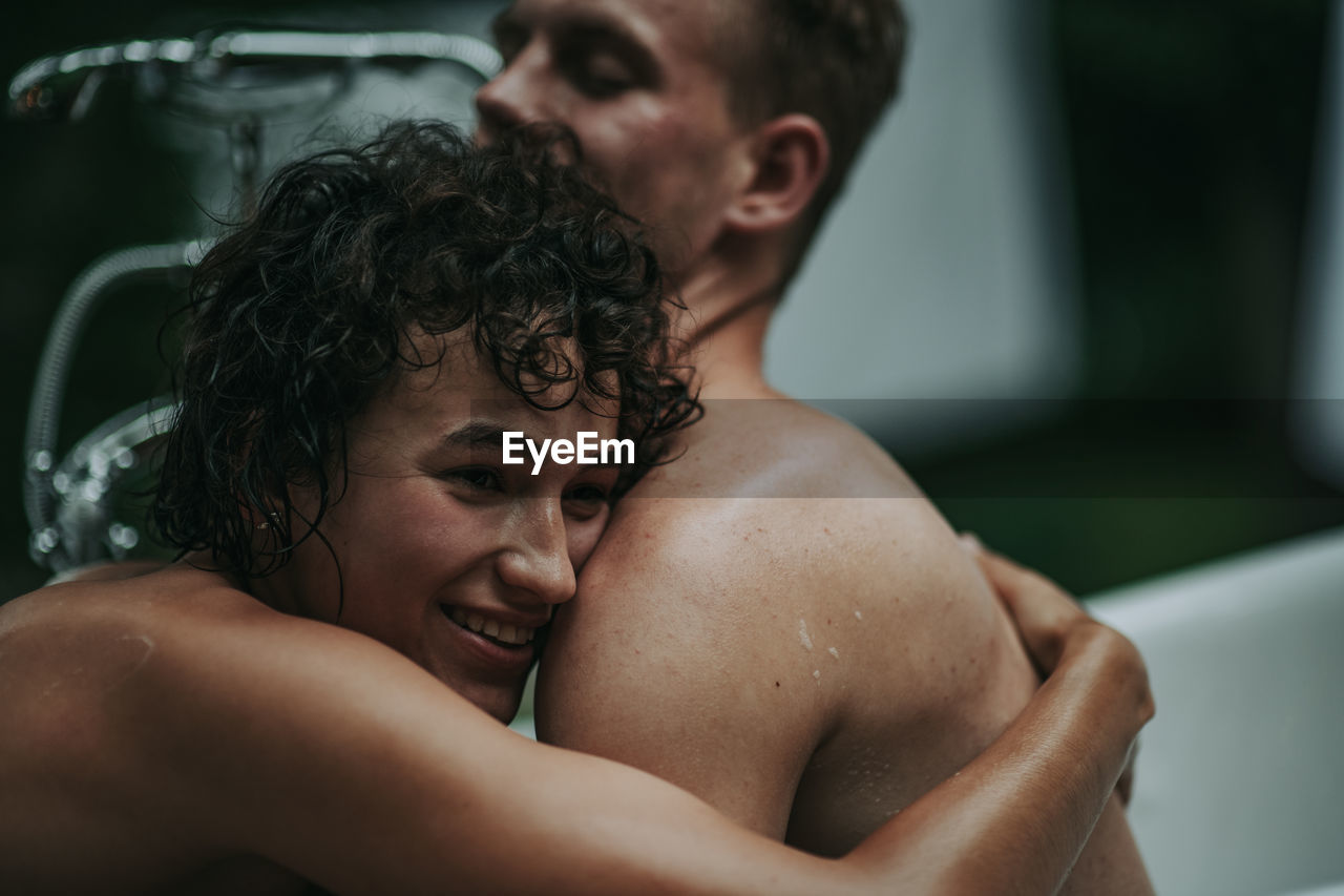 Couple in bathtub outdoors