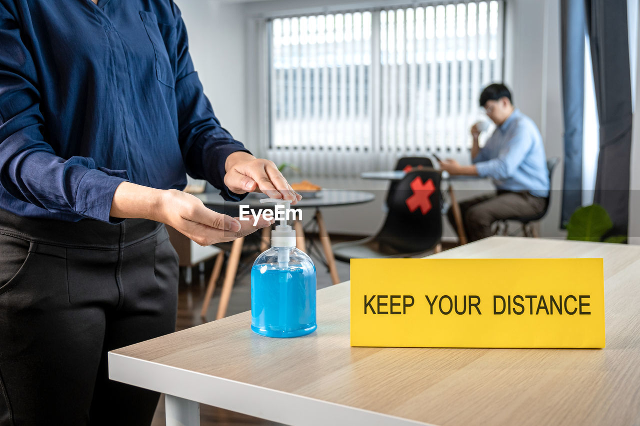 PEOPLE WORKING ON TABLE IN OFFICE