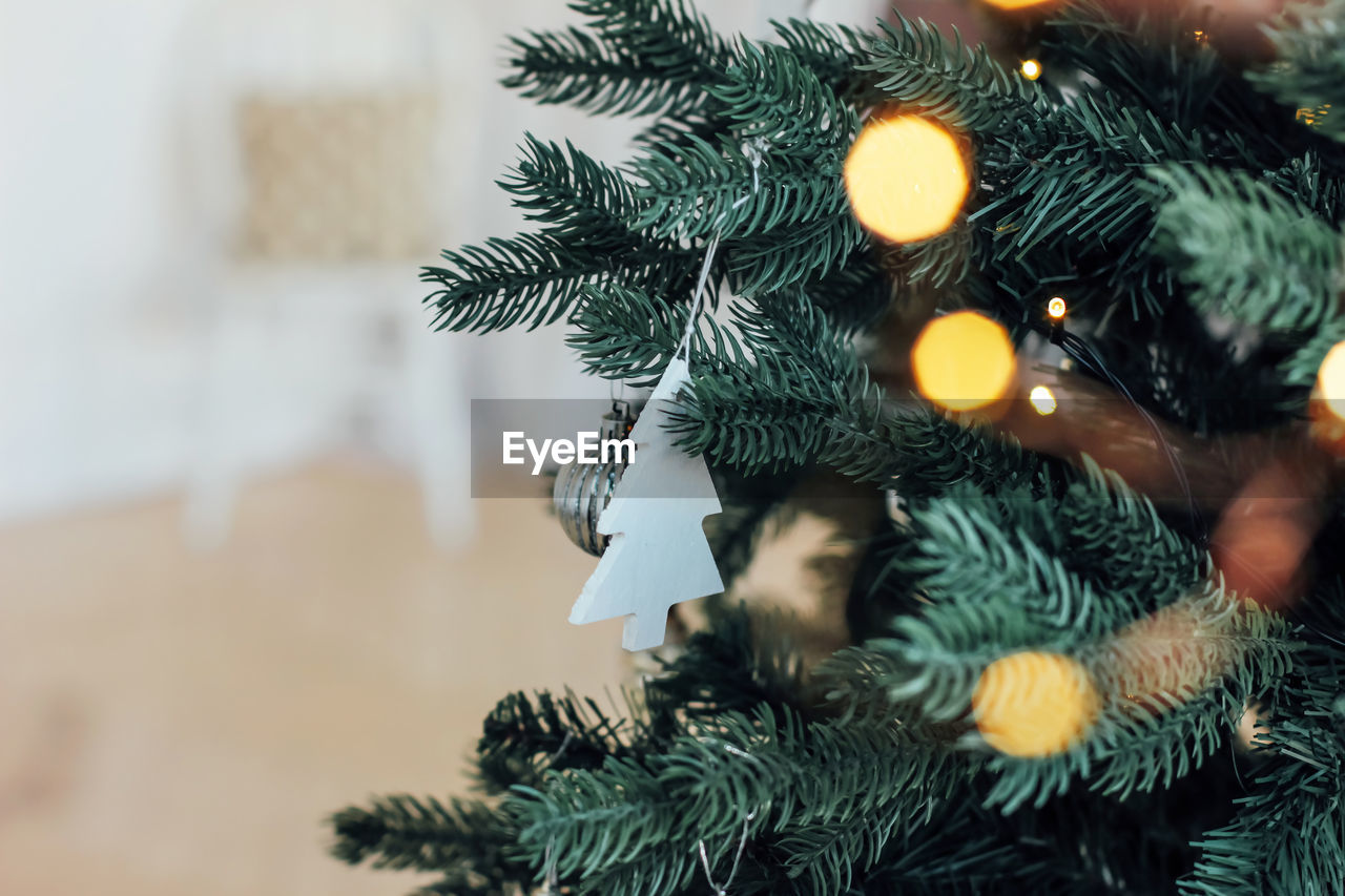 Close-up of decorations hanging on christmas tree at home