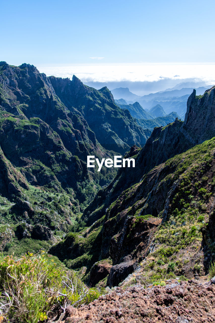 SCENIC VIEW OF MOUNTAIN VALLEY AGAINST SKY