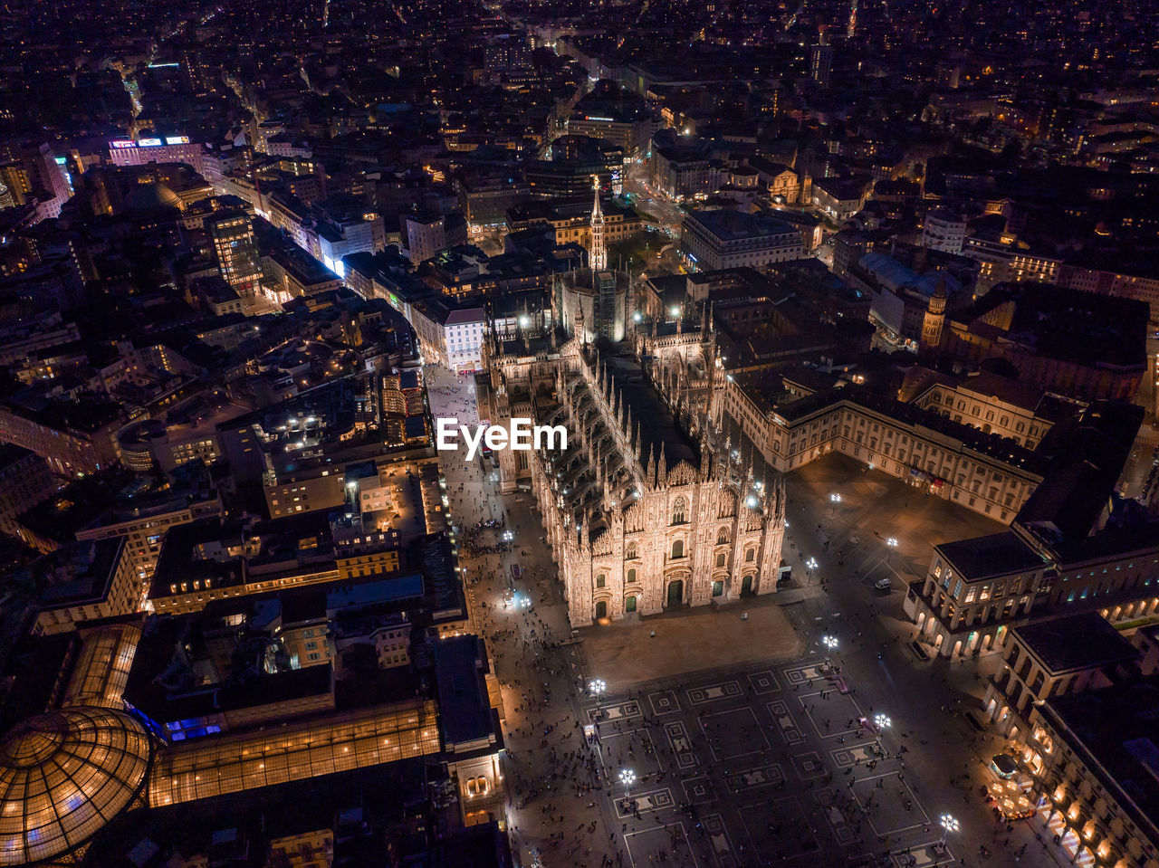 Aerial view of piazza duomo in front of the gothic cathedral in the center of milan at night.