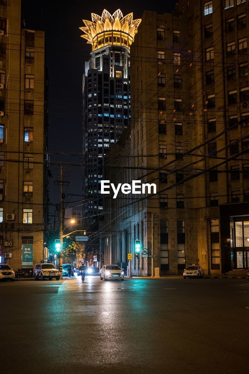 ILLUMINATED CITY BUILDINGS AT NIGHT