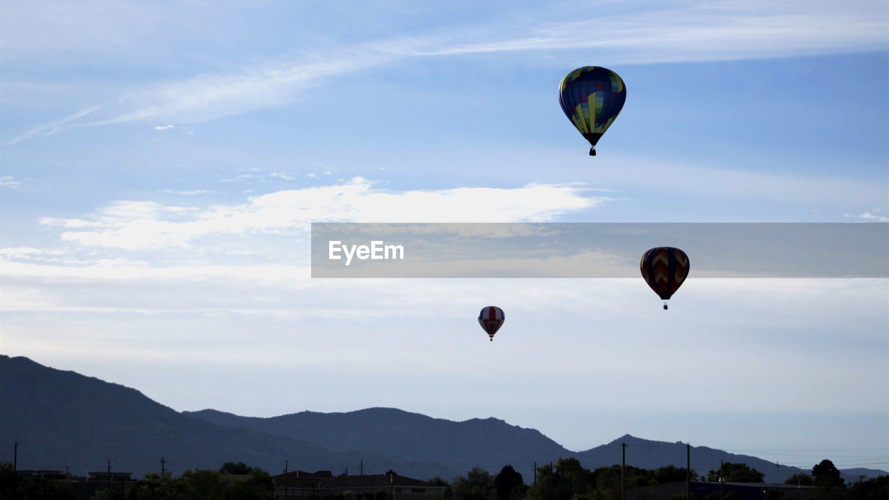 Hot air balloons in front of sandia mountains at dawn