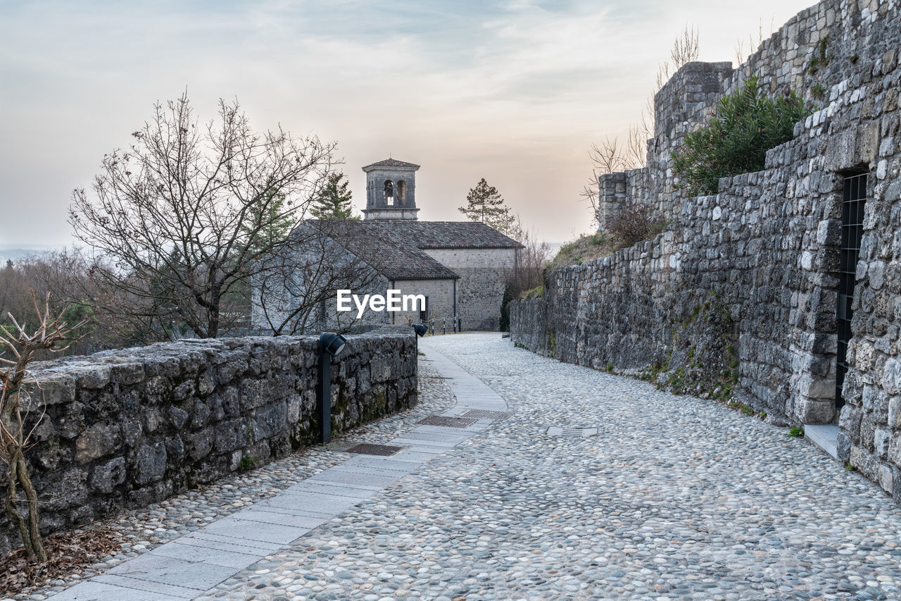 Sunset on the ancient castle of ragogna, italy. fortress guarding the ford on the river tagliamento