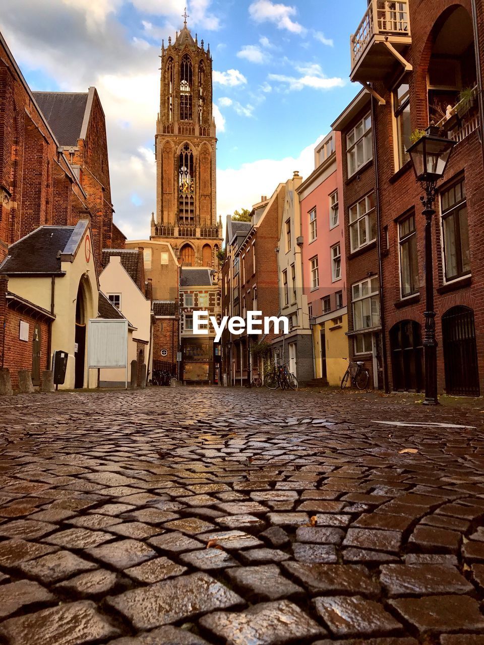 The dom church tower in utrecht viewers from the cobbled streets