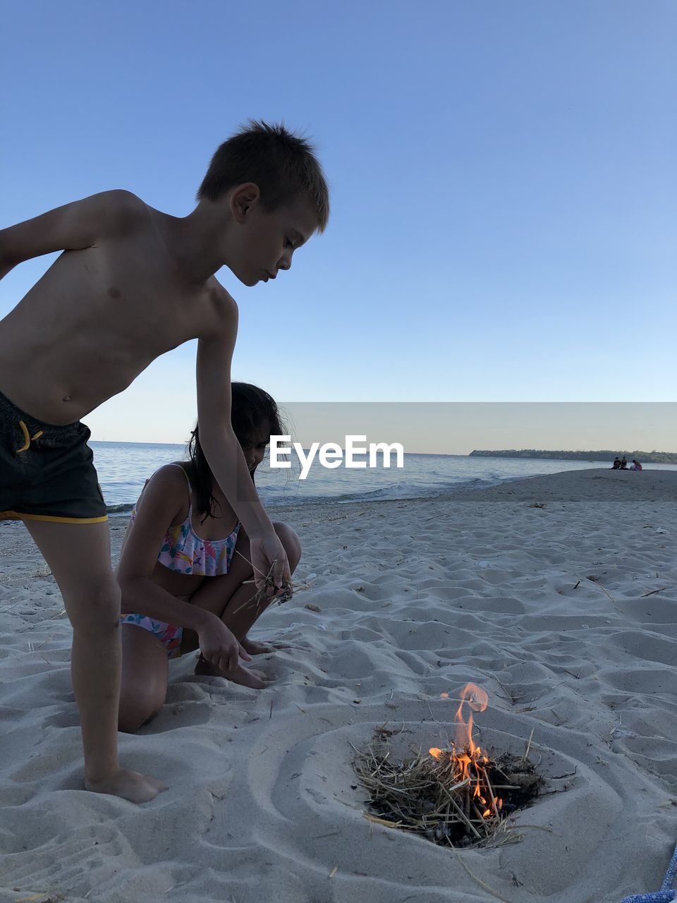 FULL LENGTH OF SHIRTLESS BOY ON BEACH