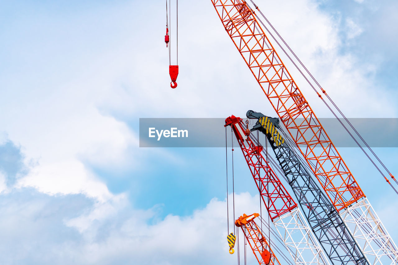 Crawler crane against blue sky and white clouds. real estate industry. red crawler crane use lift 