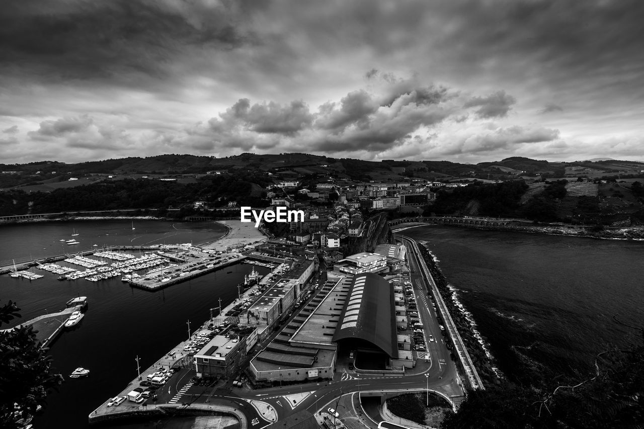 High angle view of cityscape against cloudy sky