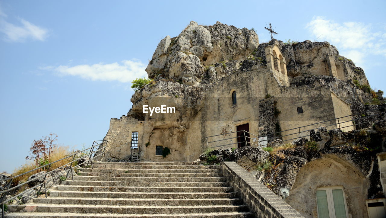 architecture, staircase, history, built structure, the past, sky, ruins, ancient history, travel destinations, steps and staircases, ancient, travel, building exterior, landmark, building, religion, temple - building, old ruin, historic site, nature, tourism, temple, archaeological site, low angle view, belief, cloud, old, spirituality, place of worship, vacation, ancient civilization, outdoors, archaeology, day, stone material, no people, stairs, fortification, blue, ruined, tree