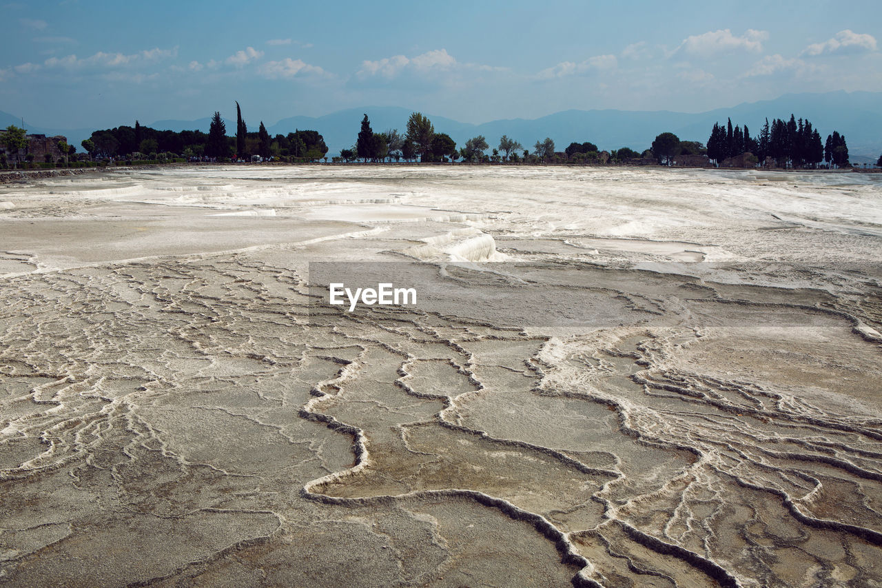 White calcium mountain with granite with small waterfall in summer in pamukkale turkey