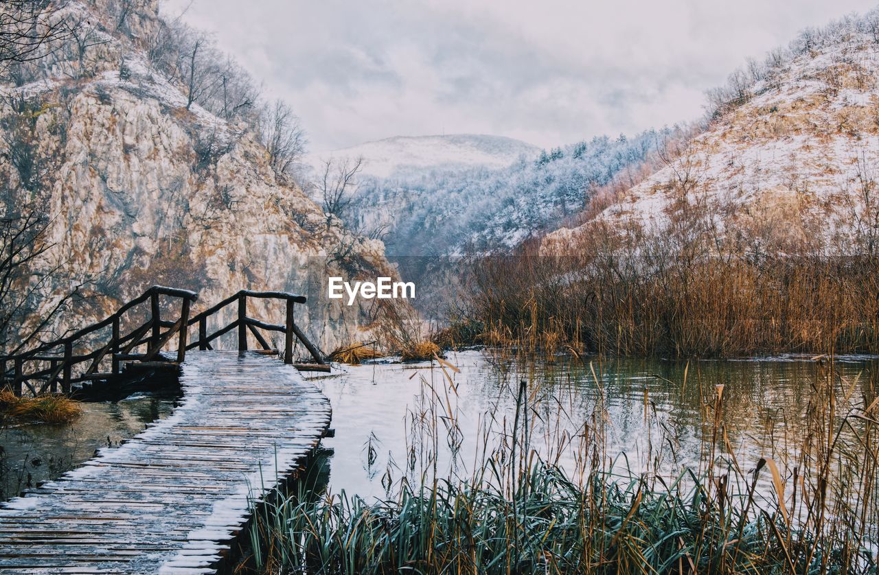 Scenic view of lake against sky during winter