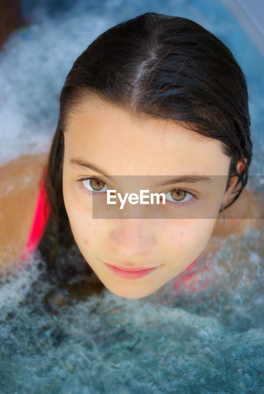 Close-up portrait of girl swimming in pool