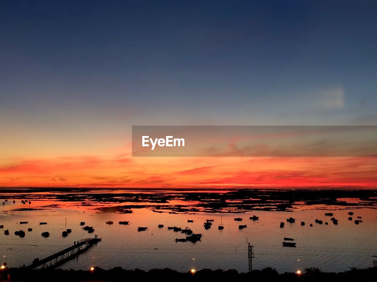 SCENIC VIEW OF SEA AGAINST ORANGE SKY