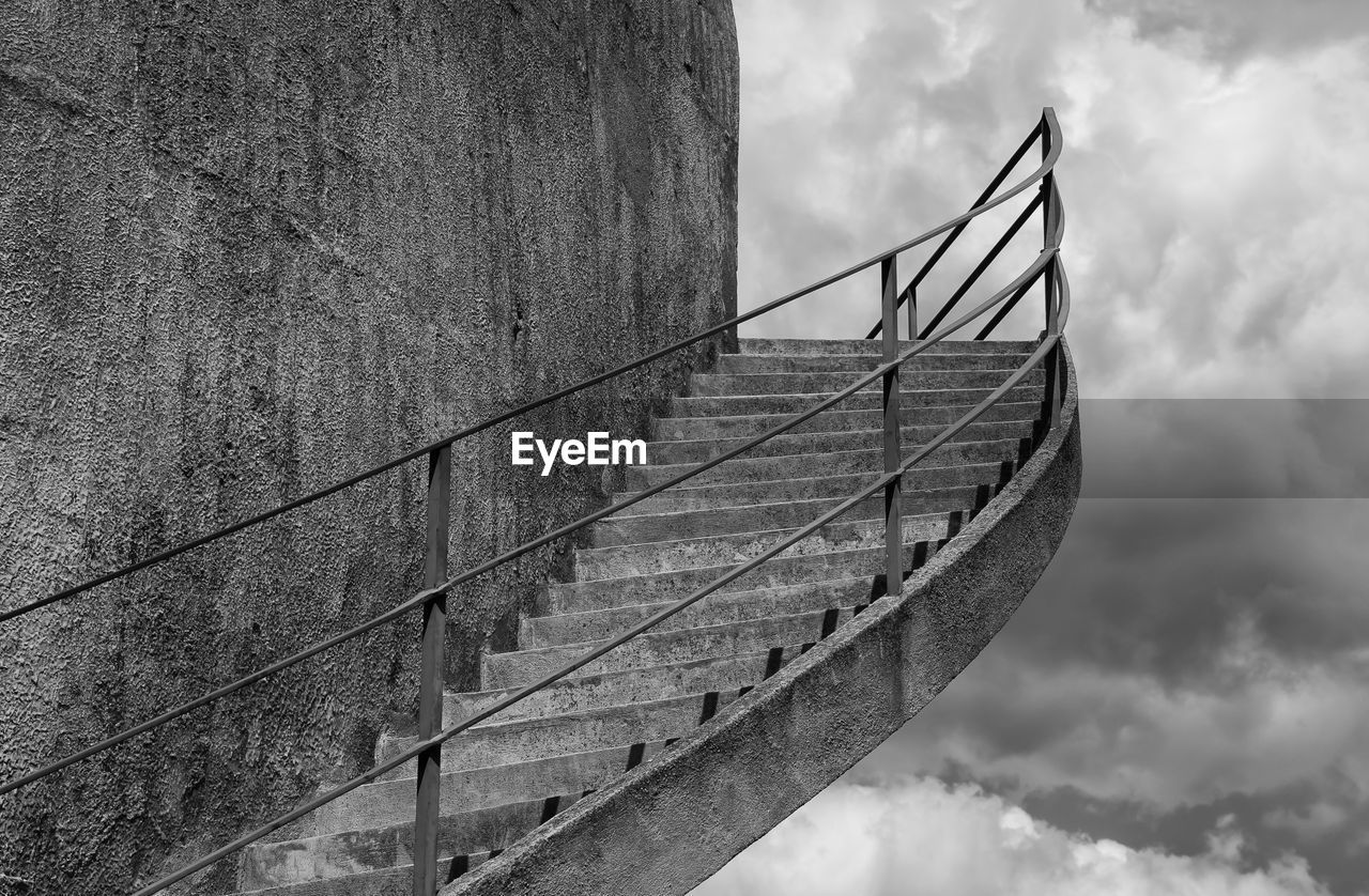 LOW ANGLE VIEW OF BRIDGE BY RAILING AGAINST SKY