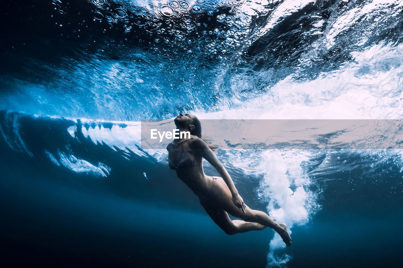 rear view of woman swimming in sea