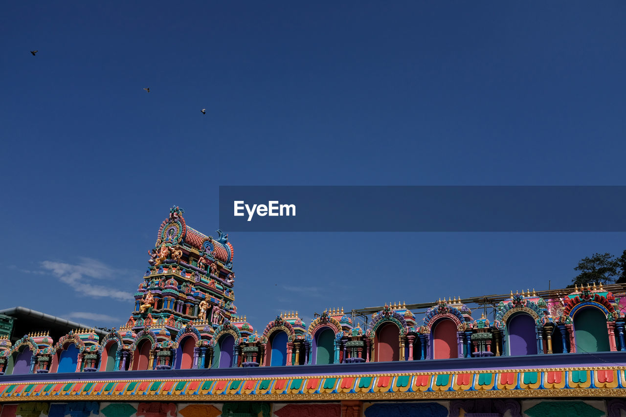 Low angle view of traditional building against blue sky