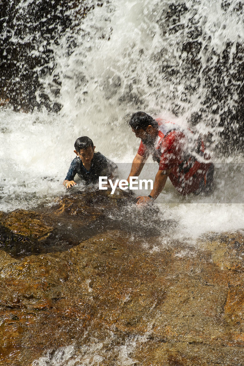 MAN SPLASHING WATER