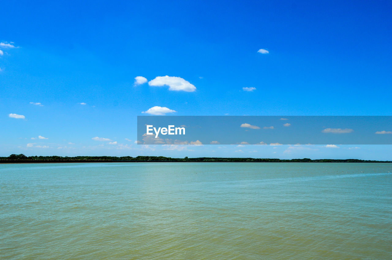 Scenic view of sea against blue sky