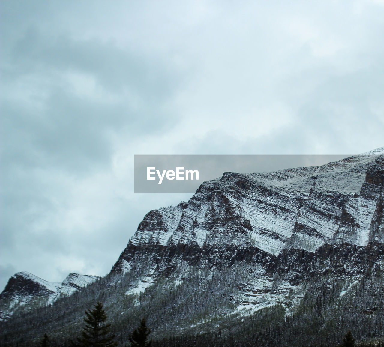 Low angle view of snowcapped mountain against sky