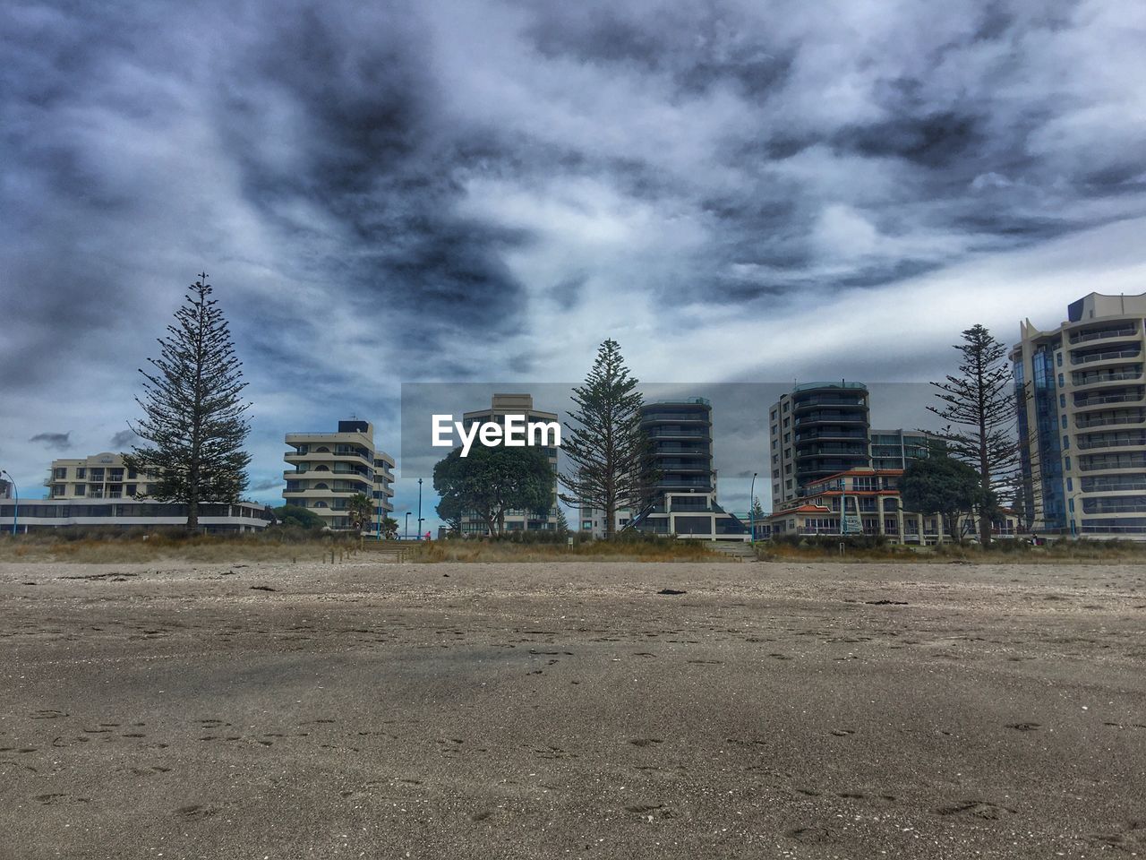 Buildings against cloudy sky