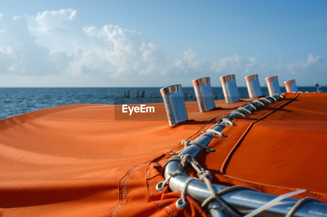 Close-up of boat at beach against sky