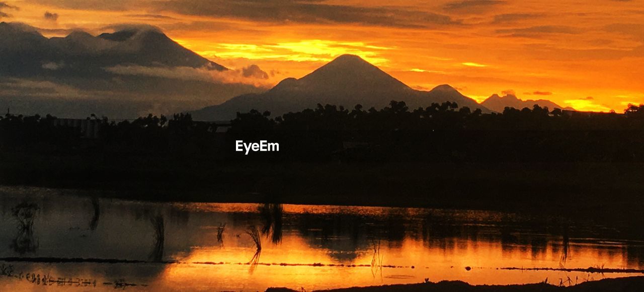 SCENIC VIEW OF MOUNTAINS AGAINST CLOUDY SKY