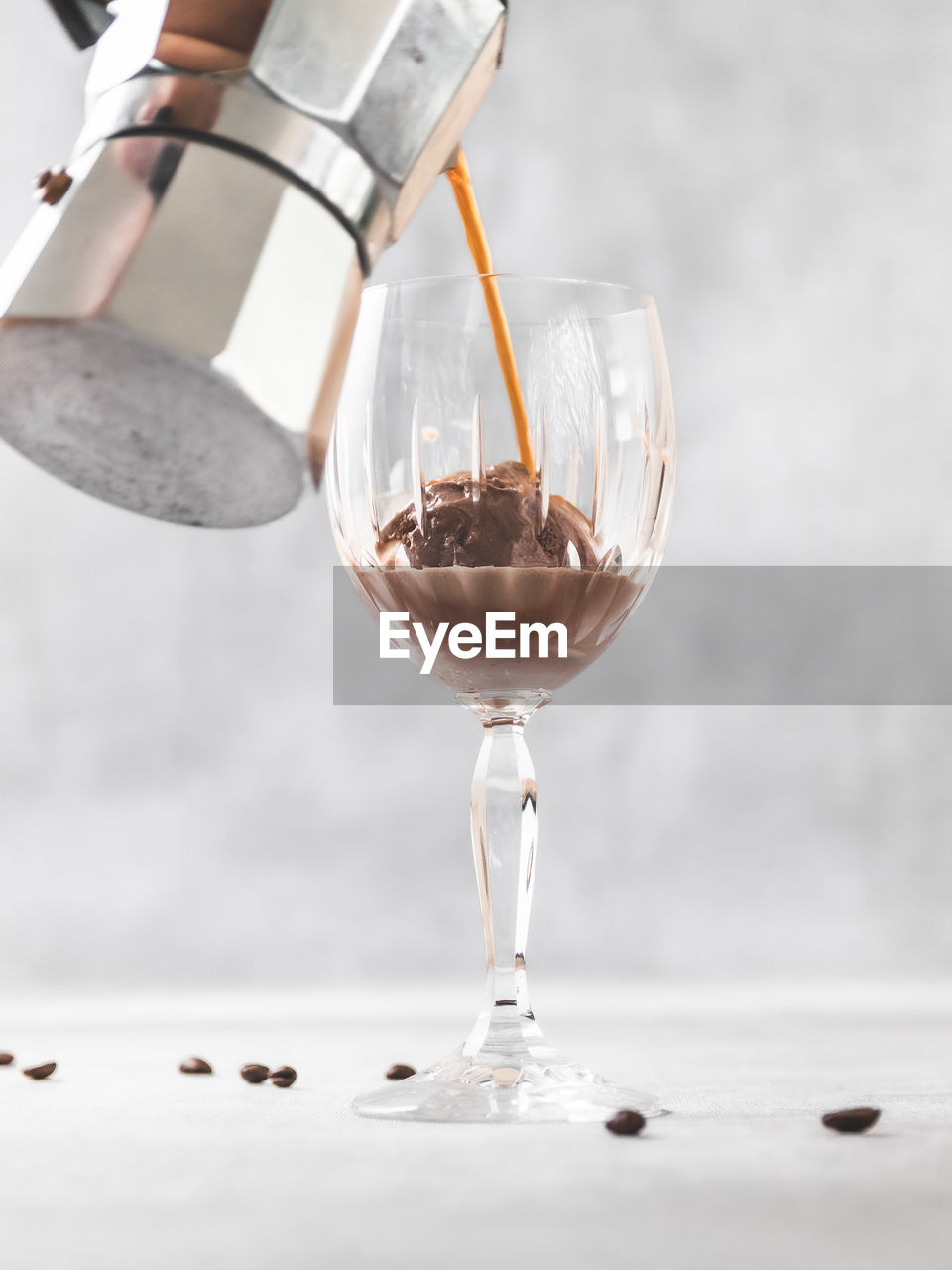 Close-up of wineglass with ice cream and coffee affogato on table