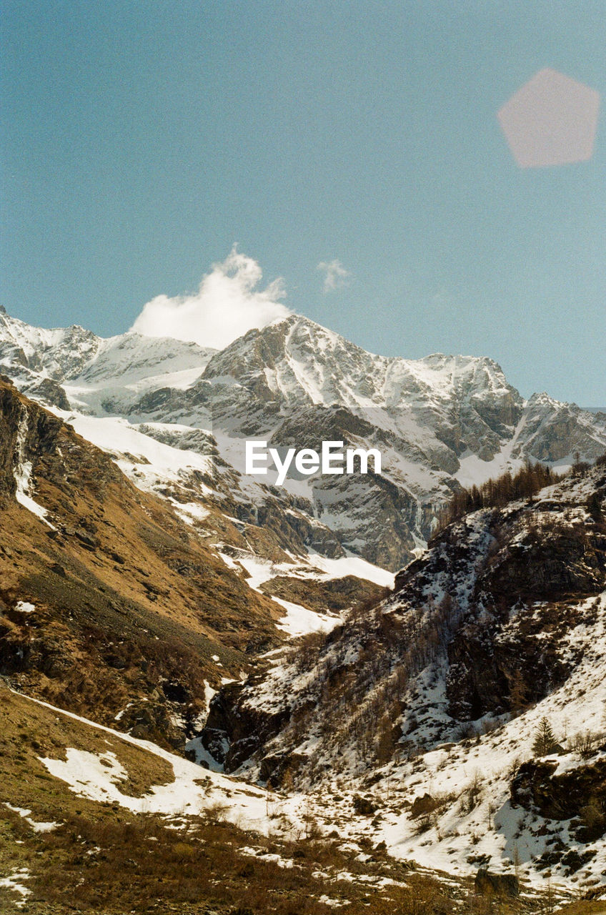 Scenic view of snowcapped mountains against sky