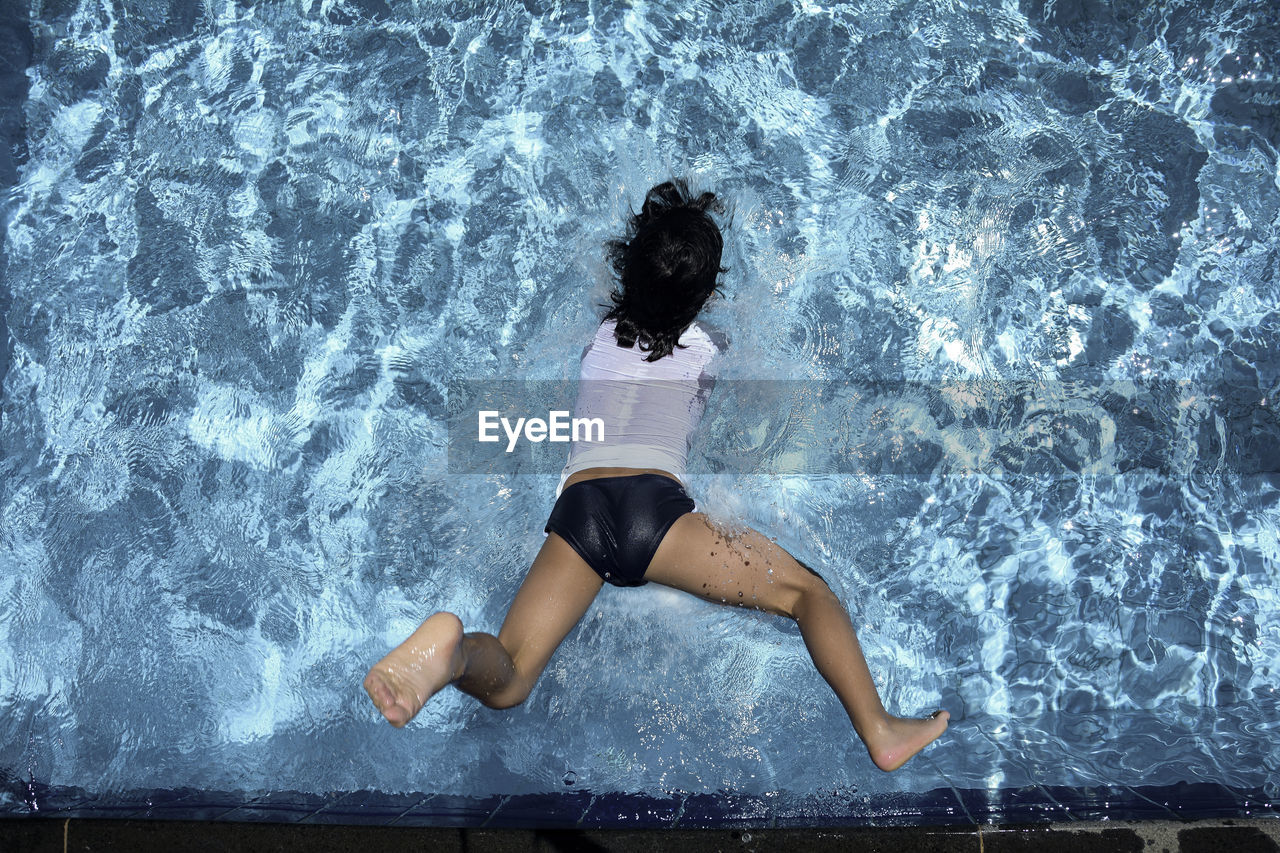 High angle view of woman diving in swimming pool