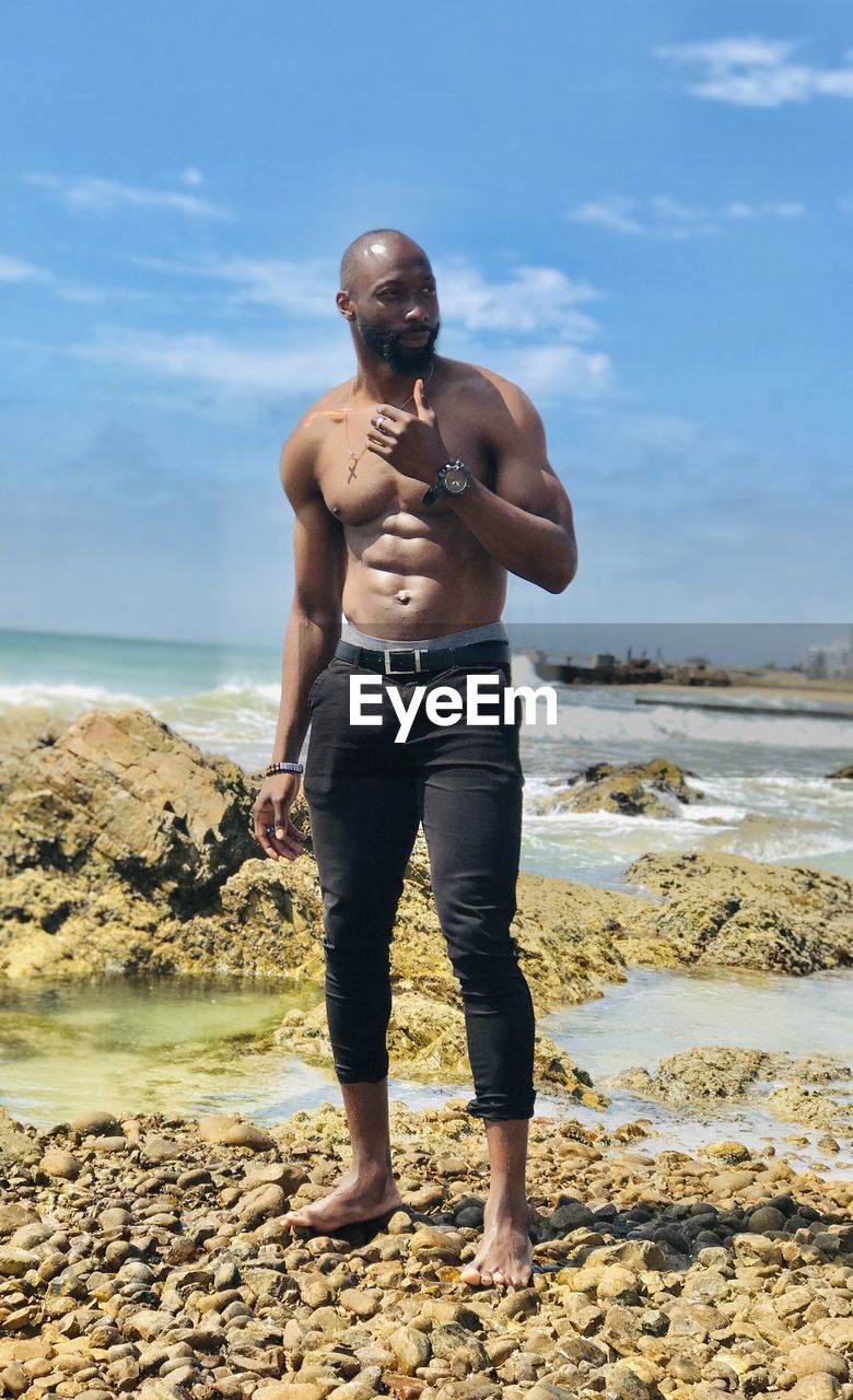 Front view of man standing at beach