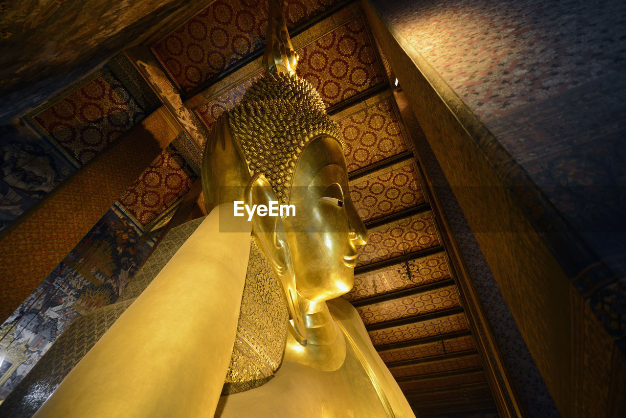 Low angle view of golden buddha statue in temple