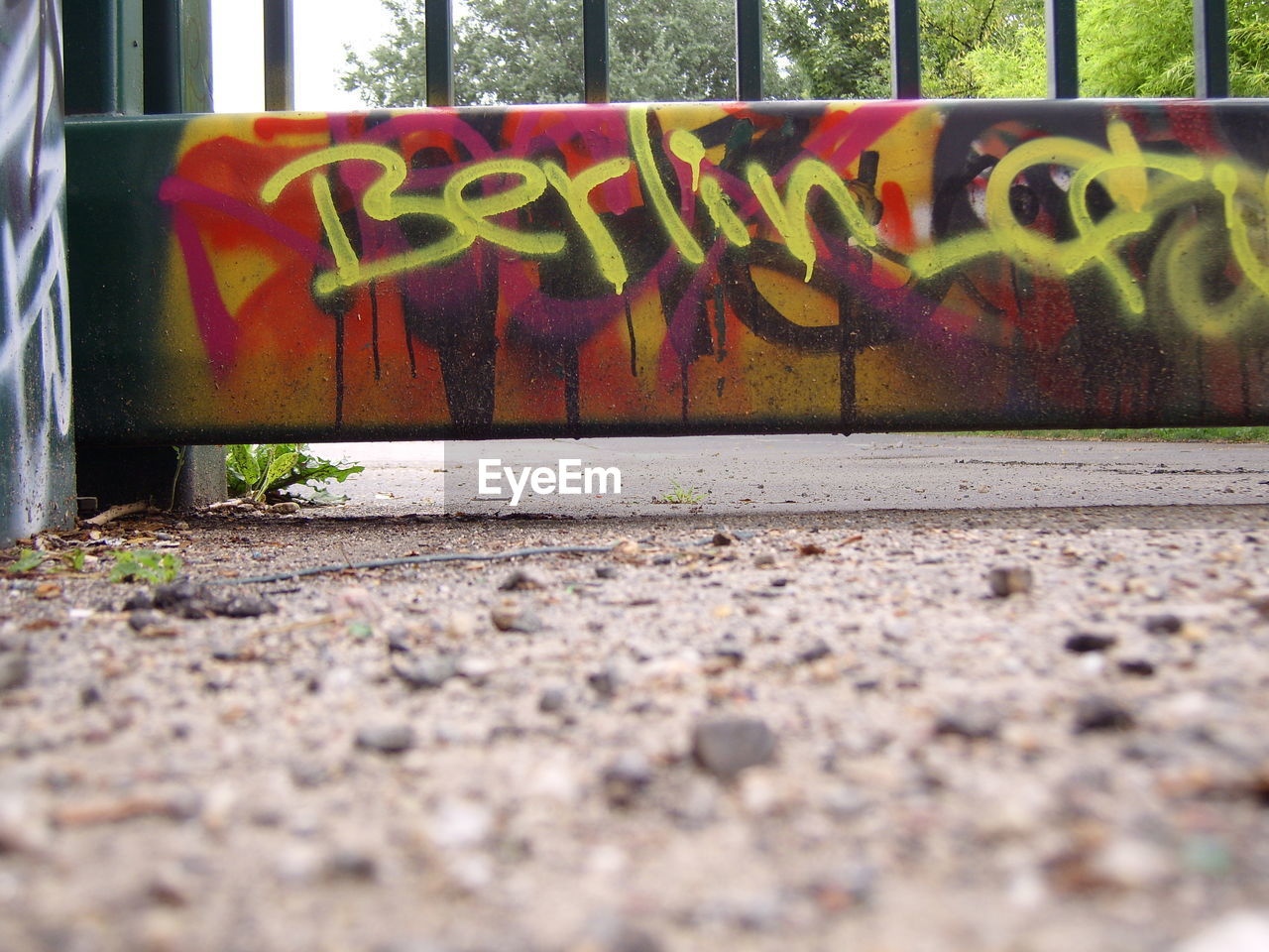 CLOSE-UP OF GRAFFITI ON RETAINING WALL AGAINST STONE