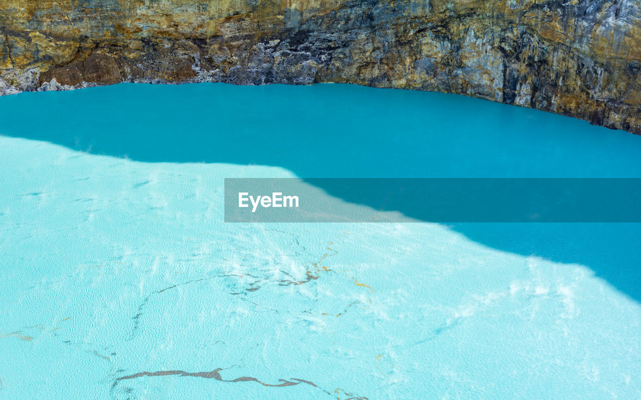 HIGH ANGLE VIEW OF SWIMMING POOL BY SEA