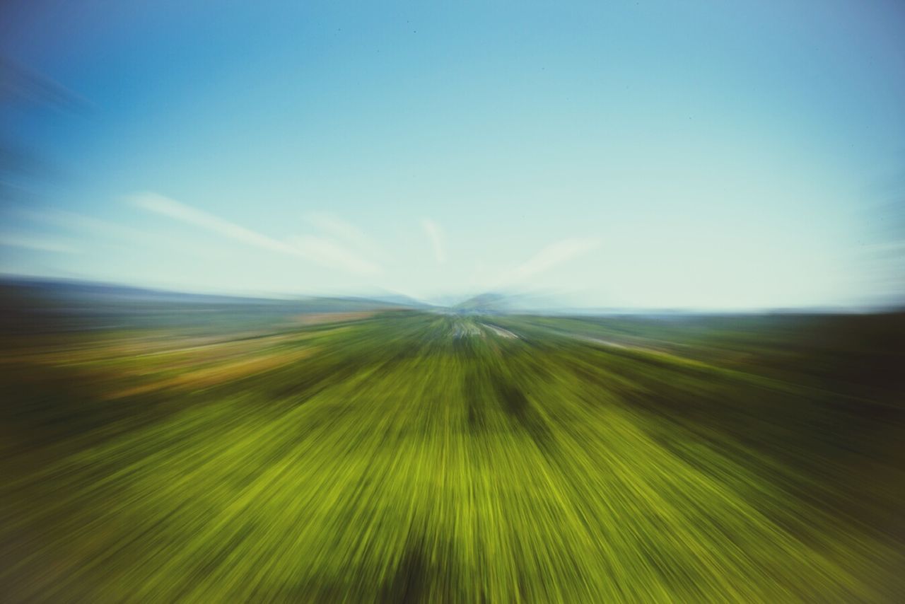 IDYLLIC SHOT OF GREEN LANDSCAPE AGAINST SKY